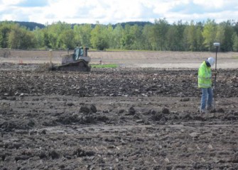 Quality Control Engineers Inspect Placement of the Clay Layer Using GPS Technology