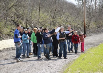 Frank Moses, director of Montezuma Audubon Center, leads a group on a birding walk near Nine Mile Creek.