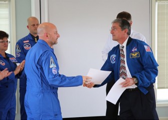 Don Thomas, currently Director of the Hackerman Academy for Mathematics and Science at Towson University in Maryland, congratulates David Chizzonite, Science Teacher at Chittenango Middle School.