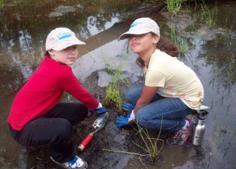 Bryant & Stratton family members don’t mind getting a little wet while becoming environmental stewards.