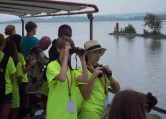 As the Emita II leaves Seneca River and enters Onondaga Lake, students use binoculars to spot birds.