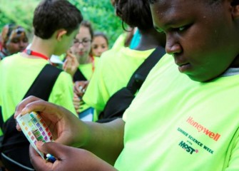 A Danforth K-8 School student assesses the pH of water from Nine Mile Creek.