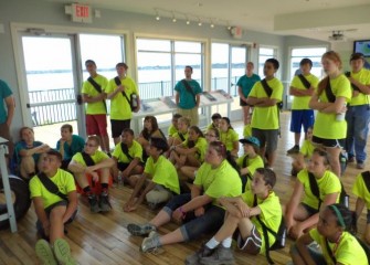 Students watch a video about the Onondaga Lake cleanup process at the Onondaga Lake Visitors Center.