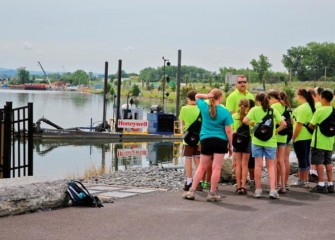 Outside the Visitors Center, a dredge used in the cleanup is brought closer to shore for students to get a better look.