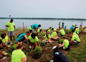 Students build a hummingbird garden, a project organized by the Onondaga Lake Conservation Corps, whose mission is to help restore and sustain the Onondaga Lake watershed.