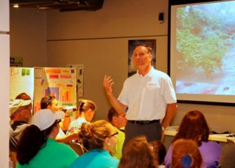 John McAuliffe talks with students about their week, commending them for their learning and engagement, and encouraging them to continue their pursuit of math, science and technology.