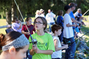 Sophia Martone, of Onondaga Hill, N.Y., learns how to fish at the 2013 Honeywell Sportsmen's Days at Carpenter's Brook.