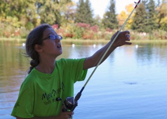 Participants learn about habitat and conservation while engaging in various outdoor sporting activities. Sophia Martone, of Onondaga Hill, checks her line before casting.