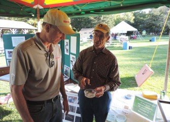 Les Monostory (right), instructor of aquatic ecology at Izaak Walton League, explains to John McAuliffe, Honeywell Syracuse Program Director, how various larvae, crayfish and other trout food sources are indicators of a stream’s health.