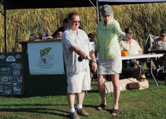 Victoria Lane (right), Trout Unlimited Board Member and Women’s Fly Fishing Seminar Instructor, gives Charles Babcock of Liverpool some tips on fly casting.