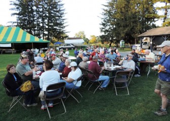 Volunteers who help make Honeywell Sportsmen’s Days at Carpenter’s Brook possible share dinner together Saturday evening.