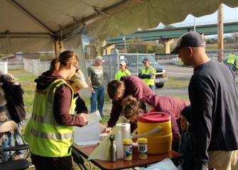 Onondaga Lake Conservation Corps volunteers arrive on a Saturday morning and sign in at the main tent.