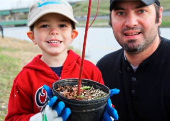 As new plants mature, this young Corps volunteer will be able to look back and remember when he helped plant this tree important to the Onondaga Lake watershed.