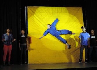 LaFayette seventh-grader Joshua Denue “hangs out” while Sharmaine Tate explains Newton’s First Law of Motion, inertia.