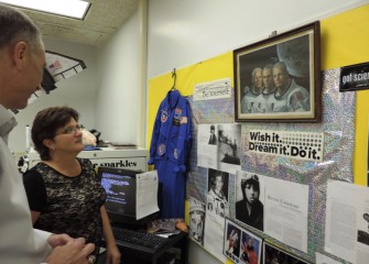 After the performance, Linda Trippany, 2013 alumna of Honeywell Educators @ Space Academy, shows Honeywell Syracuse Program Director John McAuliffe her classroom and Space Academy display.