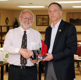 John McAuliffe (right), Honeywell Syracuse program director, presents Steve Wowelko with the Honeywell Hometown Heroes Award.  "I am humbled and honored to accept this award," said Wowelko. "What is most gratifying is seeing how many community members participate in Honeywell Sportsmen's Days at Carpenter's Brook to learn about conservation and stewardship taking place in their own communities. It means so much to know that a company is open to listening and incorporating ideas into such a significant project as the revitalization of Onondaga Lake."