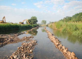 A temporary access road is built into the creek to allow excavators to access both sides of the stream.