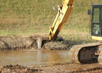 Sediment removal continues downstream along Nine Mile Creek toward the mouth of the creek.