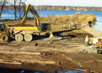 Temporary plank roads allow equipment to move about without sinking into the soft ground.