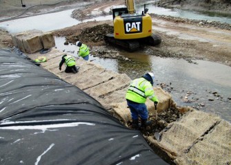 Gabions are seeded and covered with natural erosion control fabric. The seeds will germinate in spring.