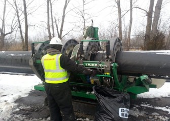 Workers inspect and replace pipe during dredging shutdown over the winter months. Here new sections of replacement pipe are welded together.