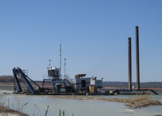 The largest of the three dredges removes material close to the shoreline.