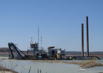 The largest of the three dredges removes material close to the shoreline.