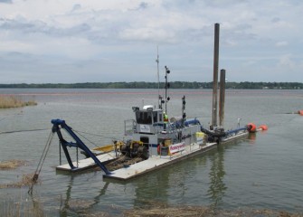 The medium-sized dredge works near the mouth of Nine Mile Creek.