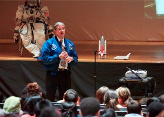 The “astronaut” seated on stage is an actual space suit Dr. Thomas brought to show students.