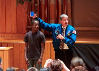 Lincoln Middle School student Egal Adan participates in a gravity demonstration.