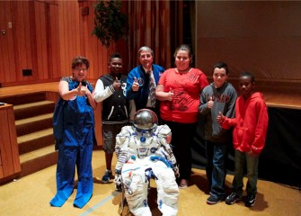 New Honeywell Educator Linda Trippany, former astronaut Donald Thomas and Lincoln Middle School students give thumbs up after the assembly on science and exploration sponsored by Honeywell.