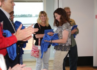 Pine Grove Middle School teacher Carolyn Scott is congratulated by fellow teachers as she receives her flight suit.