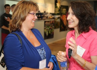 Teacher Tammy Annicharico (left) from Camillus Middle School shares a light moment with colleague Suzanne Potrikus, a 2009 alumna of Honeywell Educators @ Space Academy.