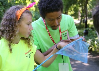 Megan Delia, a student from Camillus Middle School, tries to identify an insect with help from Counselor Marcel Young-Scaggs, a graduate of Syracuse University’s L.C. Smith College of Engineering and Computer Science.