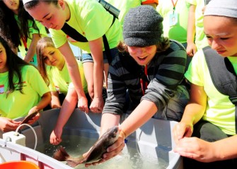 Luke Burgess, from Expeditionary Learning Middle School in Syracuse, holds a freshwater drum, also called sheepshead.