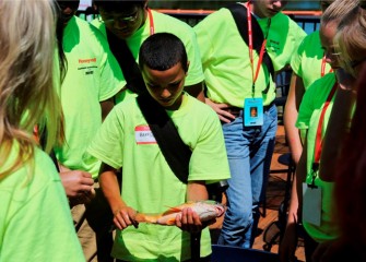 Brandon Lucio, from Solvay Middle School, examines the colorful underside of a freshwater drum.