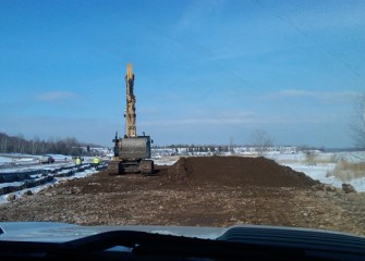 Clean imported soil is stockpiled for placement along the shoreline.