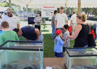 Visitors at Honeywell’s tent enjoy the exhibits and learn more about the Onondaga Lake cleanup.