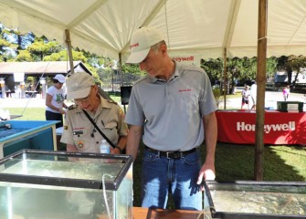 Don Augustine, left, a Boy Scouts of America aquatics instructor, views fish on display with Honeywell Syracuse Program Director John McAuliffe.