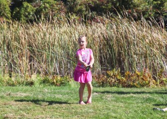 Isabella Fazio, from New Woodstock, casts her fly fishing line into the water.