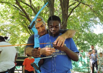 In addition to crossbow, there is an archery area at Honeywell Sportsmen’s Days at Carpenters Brook.  Quamiar Evans learns how to nock an arrow on the bowstring.