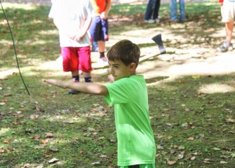 In another area of the park, participants learn how to throw a tomahawk.  Maxwell Broccoli aims for the round wood block target.