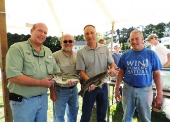 Showing off a pair of healthy largemouth bass from Onondaga Lake are from left William Lansley, Onondaga County Parks commissioner; Stephen Wowelko; John McAuliffe; and David Simmons, president of the Onondaga County Federation of Sportsmen’s Clubs.