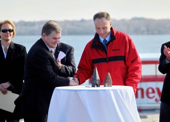 New York State Department of Environmental Conservation Regional Director Ken Lynch, left, and Honeywell Syracuse program director John McAuliffe shake hands after signing documents marking the end of dredging in Onondaga Lake.