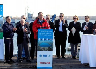 Honeywell Syracuse Program Director John McAuliffe, surrounded by community members and elected officials, announces the end of dredging.  About 2.2 million cubic yards of material were removed from the lake bottom.