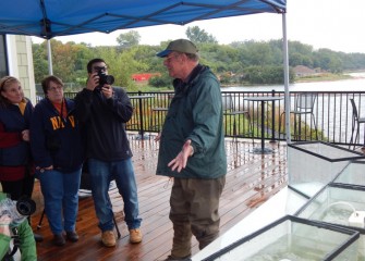 Participants listen as Neil Ringler, Ph.D. (right), fisheries expert and vice provost of research at SUNY-ESF, gives an overview of the fish communities in Onondaga Lake.