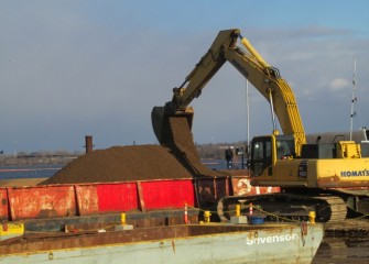 Capping material is loaded into a barge for placement during the final weeks of 2013 capping operations.