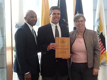 Chris Lajewski, director of Montezuma Audubon Center, accepts a 2015 Environmental Champion Award from EPA Regional Administrator Judith Enck on behalf of the Onondaga Lake Conservation Corps. Donovan Richards, Chair of the New York City Council's Committee on Environmental Protection, is on the left.