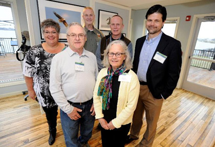 The exhibit featured images taken by local photographers (back row, left to right) Michele Neligan, Bob Walker, John Savage, Greg Craybas, (front row, left to right) Duane St. Onge, and Cheryl Lloyd (not pictured: Willson Cummer).