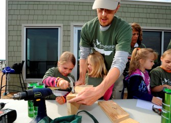 Building in the right dimensions is critical to attracting desired species. Mark Bremer, of Manlius, constructs a bird box with his daughters Sammie (left) and Ali.